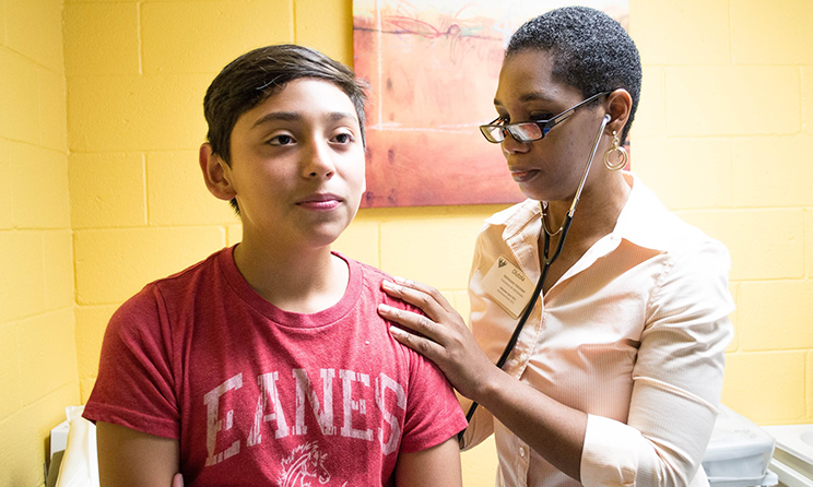 A young person is examined in a hospital clinic